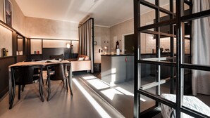 A modern interior with a dining area, a sofa, and a kitchen. - CLOUD No7 LOFTS (Stuttgart)