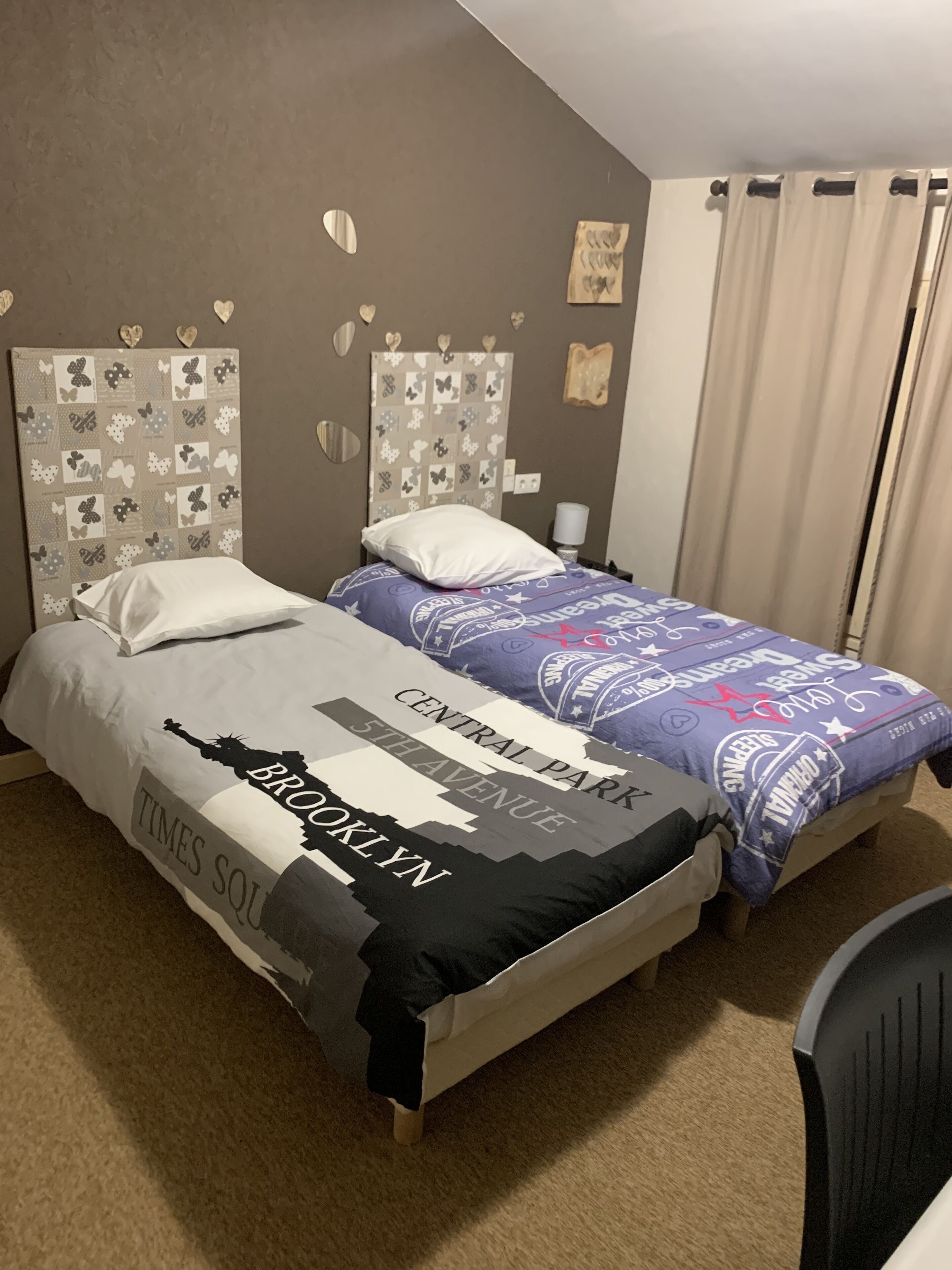 A double bed with a Times Square-themed bedspread and a Central Park-themed headboard.