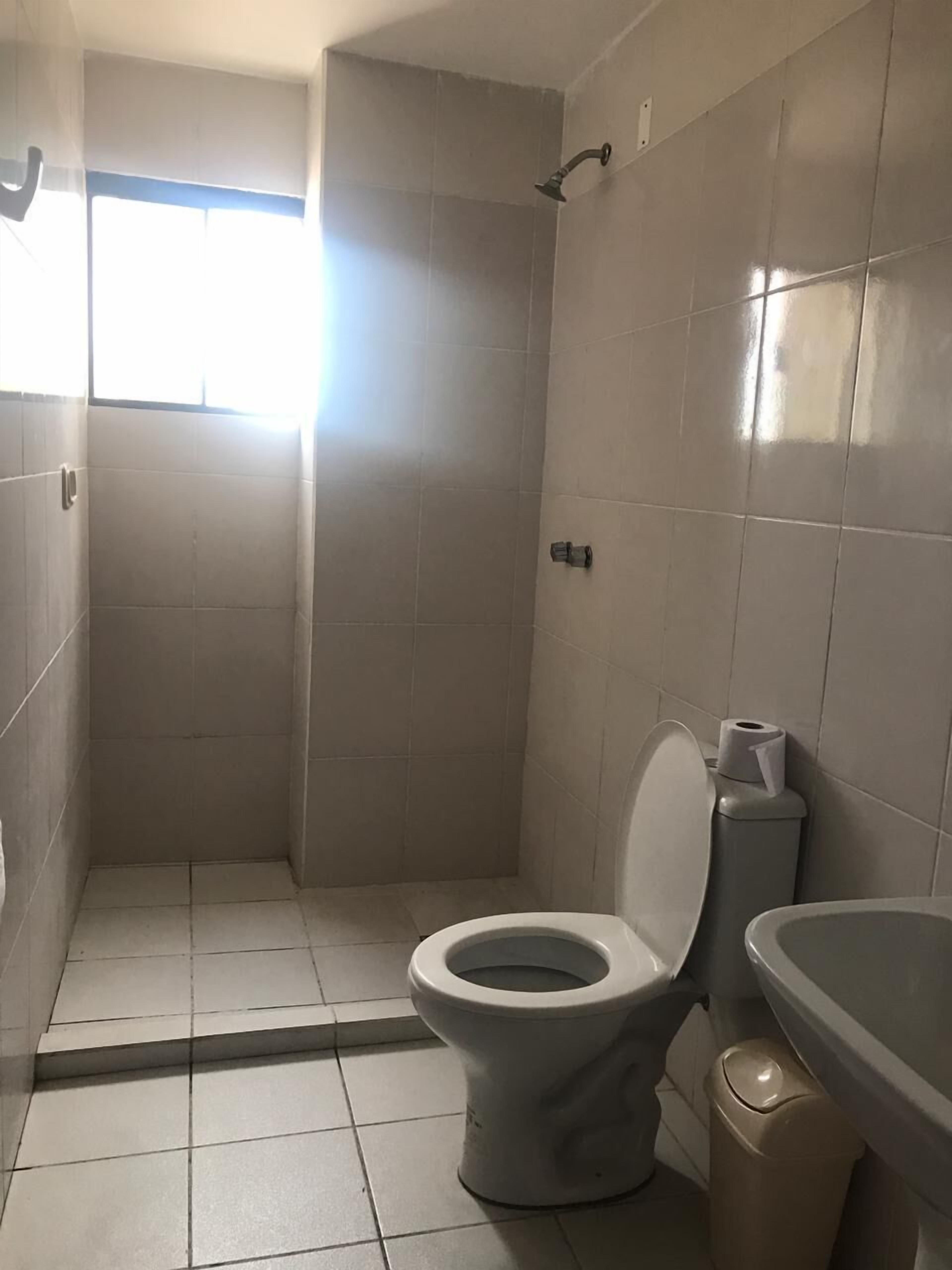 basic double room, 1 queen bed | bathroom | shower, towels, soap, shampoo