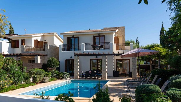 A two-story house with a swimming pool, outdoor seating, and a garden. - Villa HG24 Cardia - Three Bedroom Villa, Sleeps 6 (Kouklia)