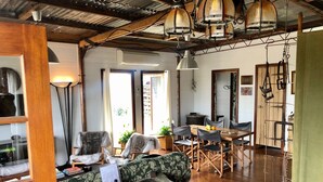 A spacious living area with a wooden dining table, two sofas, and a coffee table.