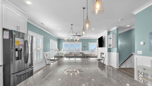 A modern kitchen with granite countertops, stainless steel appliances, and a central island. - Luna's: Amazing Ocean View House with Pool, Spa, Elevator and Electric Car Charg (Oak Island)