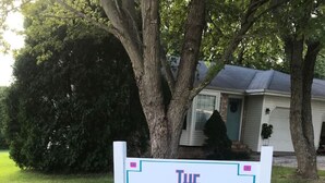 A sign that reads "The Southwest Place" in a grassy area with trees and a house in the background. - The Southwest Place 2203 (Ozark)
