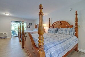A bedroom with a large bed, a smaller bed, and a balcony. - Shootout Weekend Finds Room to Spread Out (Osage Beach)