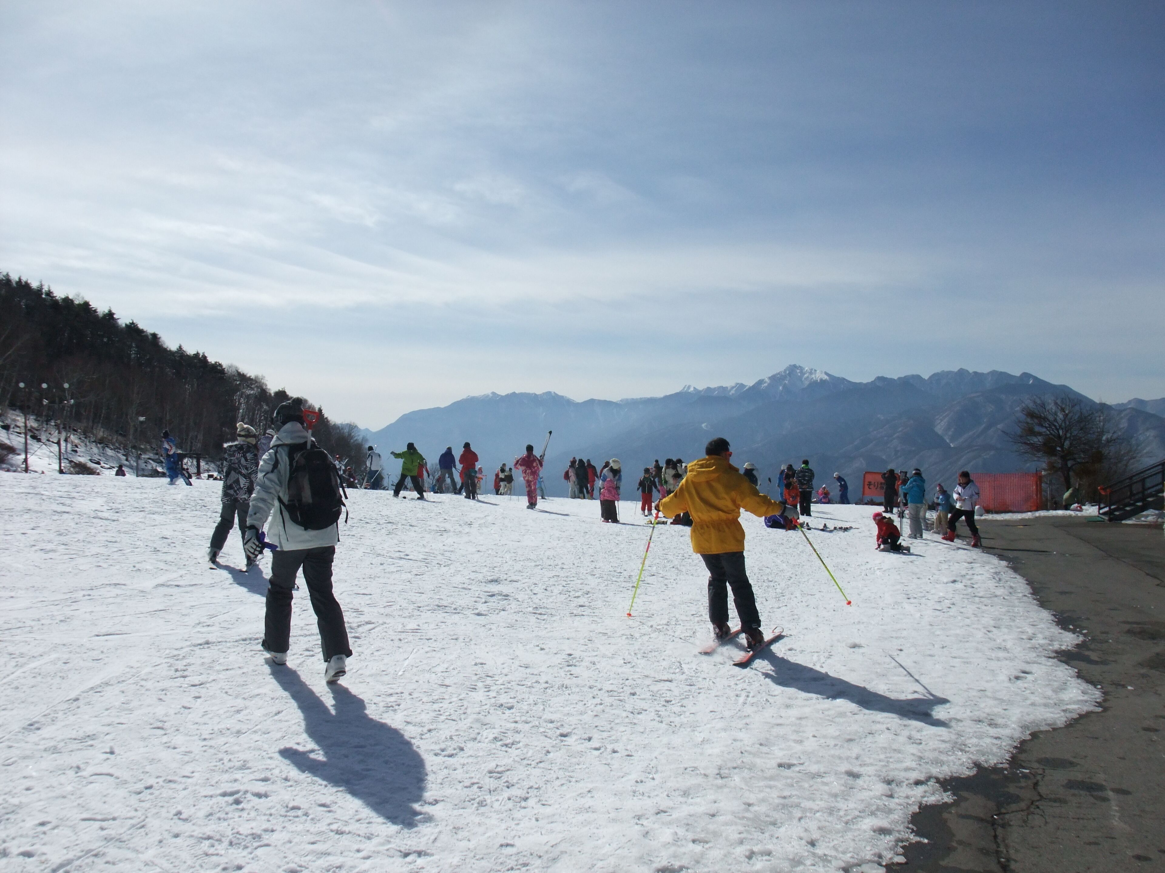 Une piste de ski enneigée, avec des skieurs et des snowboardeurs.