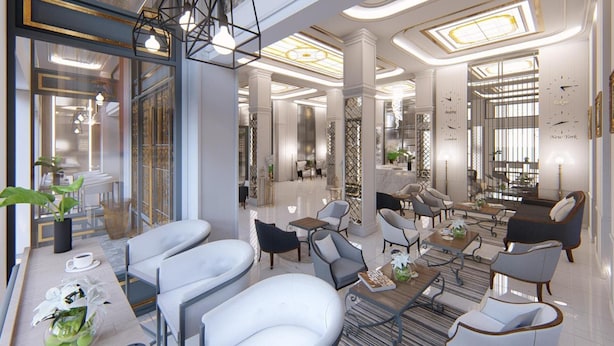 Eine großzügige Lobby mit moderner Einrichtung, einer Kaffeestation und einem Empfangsbereich.