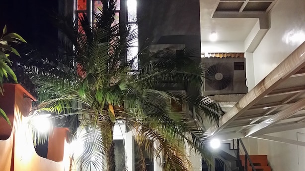 A multi-level building with a staircase, indoor plants, and a fan on the ceiling. - Exotic wind sand city 86 (Taitung)
