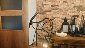 Ein rustikaler Holztisch mit einer Metallskulptur, einer Kerze und einem Laternen.