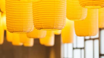 A row of hanging paper lanterns in a warm, dimly lit room.