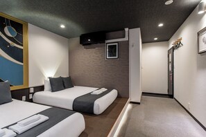 A hotel room with two beds, a large abstract painting on the wall, and a modern design.