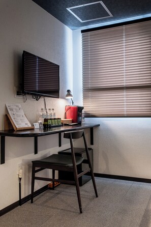 A modern office space with a desk, chair, and a mounted flat-screen TV. - Yuyu Ukiyoe Hotel (Osaka)