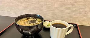 A bowl of soup and a cup of tea on a tray.