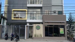 A multi-story hotel with a modern design, featuring balconies, large windows, and a prominent signage for the Nge Nathaniel Hotel. - Nathaniel Hotel (Daet)