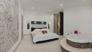 A modern bedroom with a large bed, a walk-in closet, and a separate bathroom with a jacuzzi. - Villa Martinis (Rogoznica)
