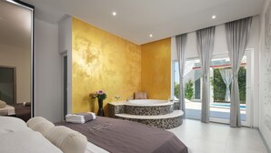 A modern bedroom with a large bed, a jacuzzi, and a view of a pool. - Villa Martinis (Rogoznica)