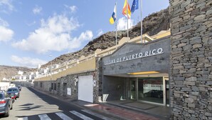 A building with a sign reading "Brisas de Puerto Rico" and flags of Spain and the European Union. - Las Brisas de Puerto Rico (Mogán)
