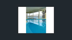 An indoor swimming pool with a clear view of the sky and a white railing. - Picturesque on Passage - Whitsundays (Shute Harbour)