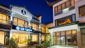 A hotel with traditional architecture, large windows, and a sign for 'Floral Hotel'. - Floral Hotel Yipin Visual Arts Xitang (Jiaxing)