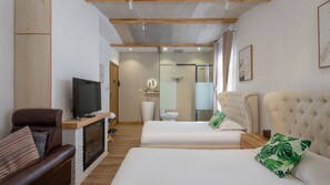 A modern hotel room with a flat-screen TV, a fireplace, a large bed with two decorative pillows, a leather armchair, and a wooden ceiling. - Floral Hotel Yipin Visual Arts Xitang (Jiaxing)