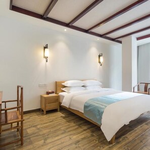 A bedroom with a wooden bed, nightstands, a chair, and two wall-mounted lights.