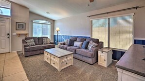 A living room with two sofas, a coffee table, a side table, and a ceiling fan. - Outdoor Kitchen, Heated Pool: Gilbert Retreat! (Gilbert)