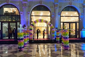 A hotel entrance with a colorful archway and a checkered floor.