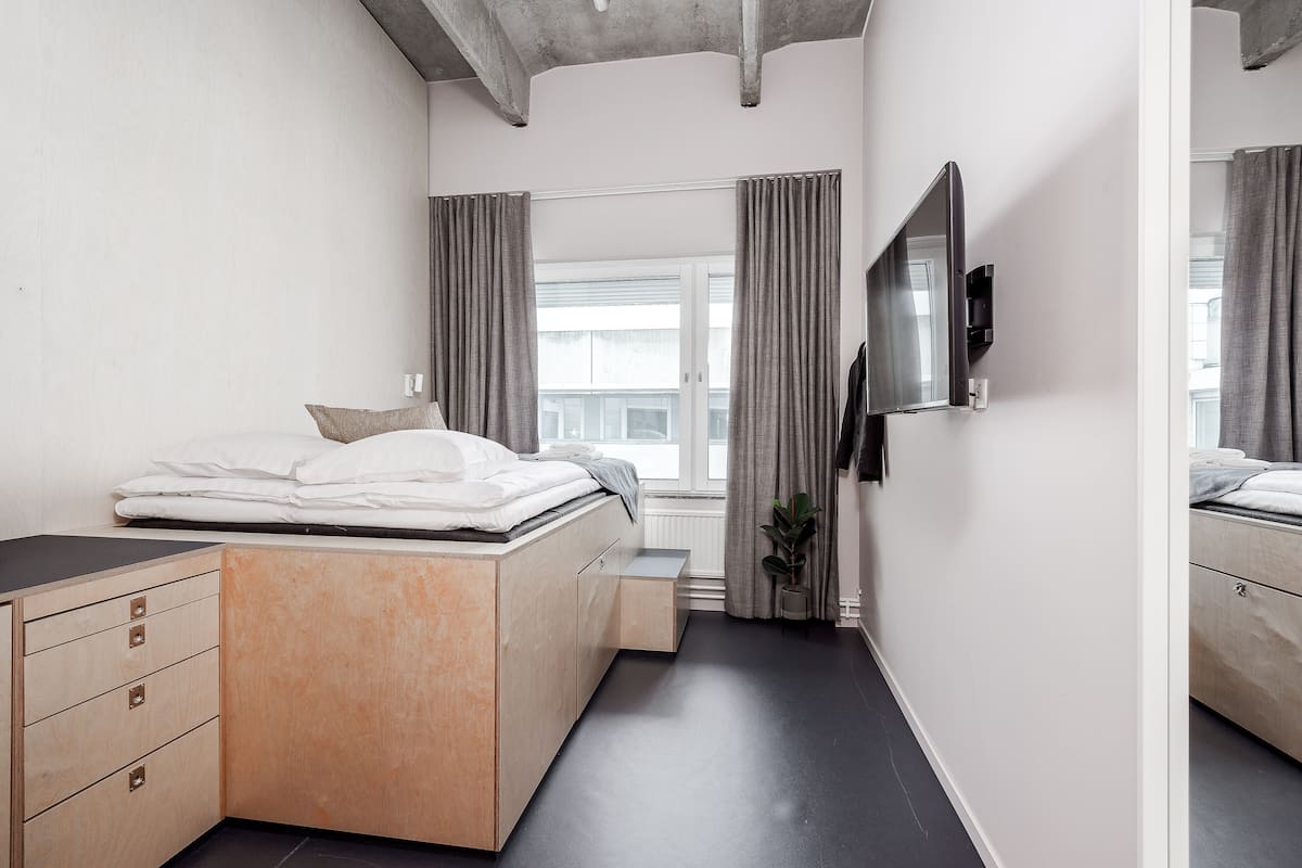 Ein modernes Schlafzimmer mit Bett, Nachttisch und Spiegel.