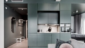 A modern kitchen with grey cabinets, a built-in oven, and a countertop with a sink. - Forenom Aparthotel Arlanda (Arlanda)