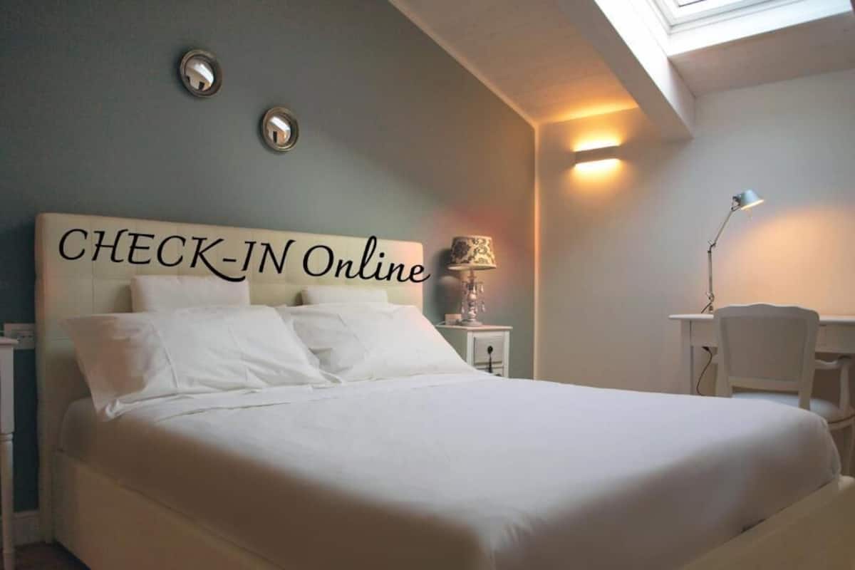 A check-in online sign above a bed in a hotel room.