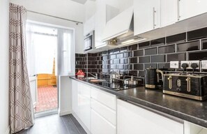 Mini-fridge, microwave, stovetop, coffee/tea maker