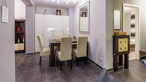 A modern room with a dining area, a wardrobe, and a mirror. - (204) 2-room apartment - Apartment house Villa Laura (Kühlungsborn)