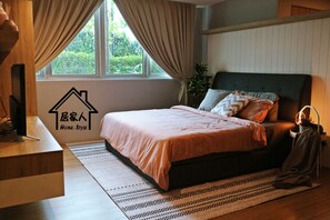 Restful retreat with a large bed, desk, and potted plant.