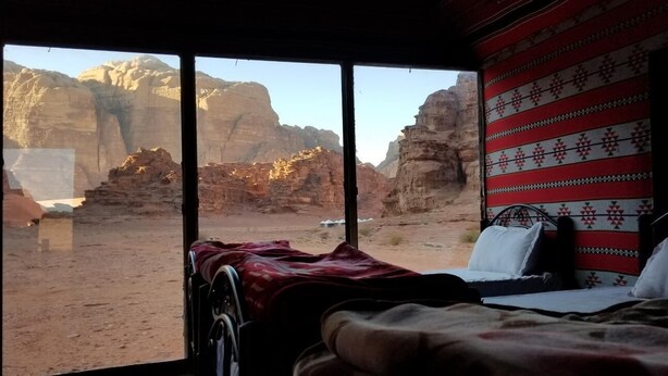 A room with a large window offering a view of rocky desert landscape. - Wadi Rum Desert Camp (Wadi Rum)
