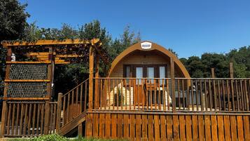 A wooden structure with a sign indicating it's a hotel named 'The Hotel by Mining Solutions.'