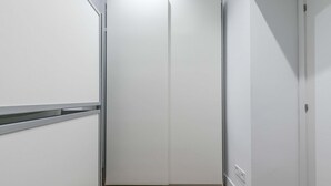 A narrow hallway with a white door at the end.