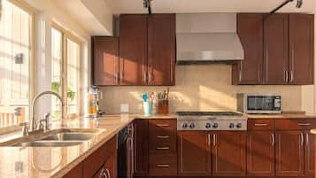A kitchen with a stainless steel range, a microwave, and a dishwasher.