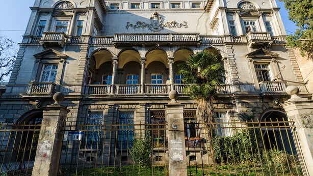 A historic building with classical architecture, featuring multiple balconies, arched windows, and a prominent entrance. - SOLO Apartment 1BR Apartment (Tbilisi)