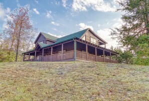 A log cabin with a green roof and a covered porch. - Luxury! 2 Master Suites w/Fireplaces|Game Room (SEVIERVILLE)