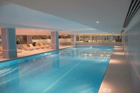 Indoor pool, pool loungers. City One Hotel & SPA