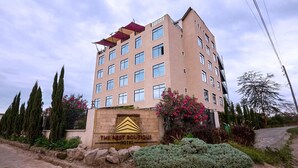 A multi-story hotel with a sign reading "The Nest Boutique Hotel." - The Nest Boutique Hotel (Naivasha)
