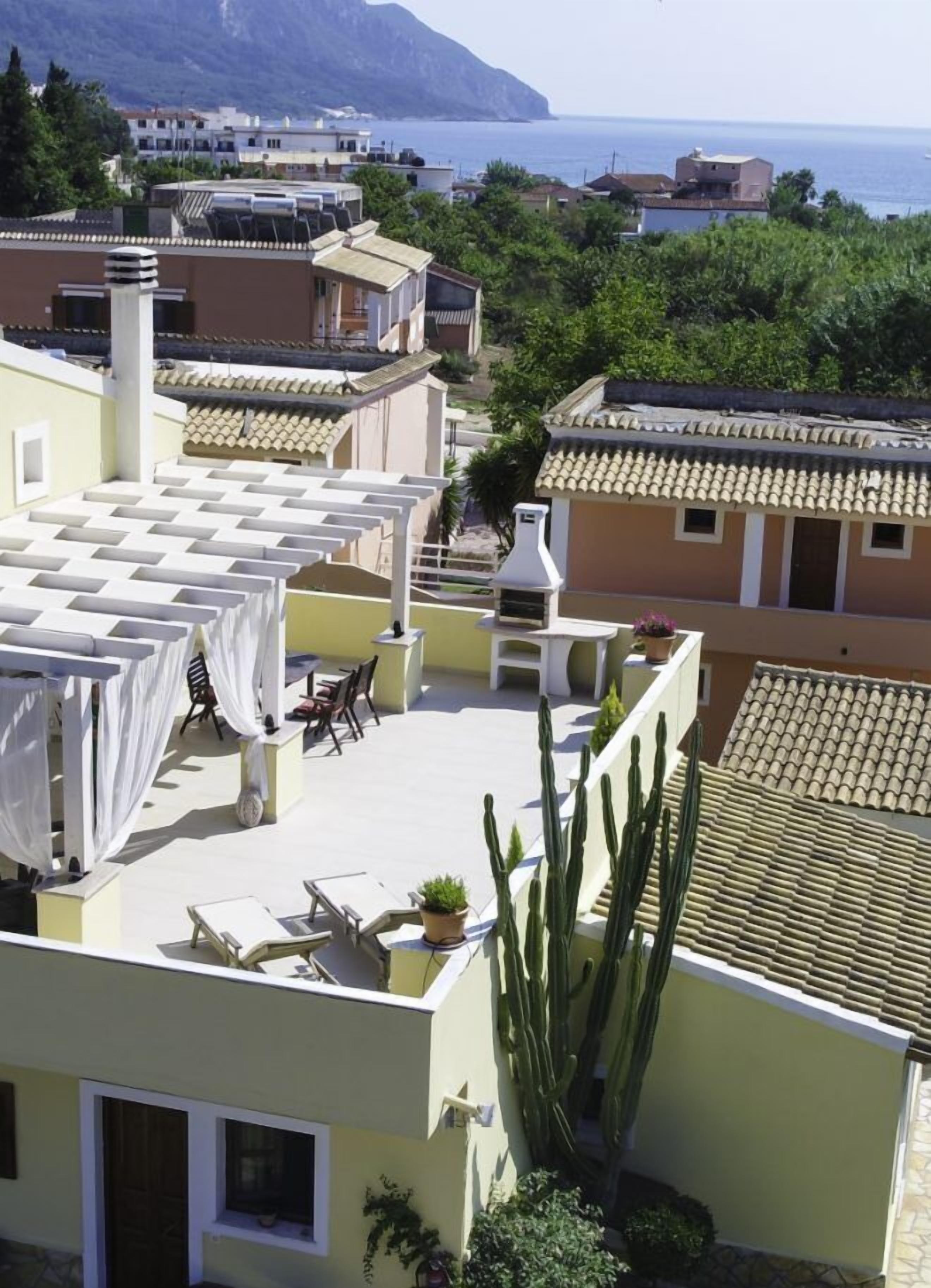 Une terrasse sur le toit avec des espaces de détente en plein air, une fontaine et des cactus.