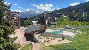 A ski resort with a ski lift, a pool, and a playground.