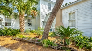 A residential area with white houses, palm trees, and a variety of tropical plants. - Heart of Historic Apalachicola, Nostalgic Florida “Blue Moon Cottage ” (Apalachicola)