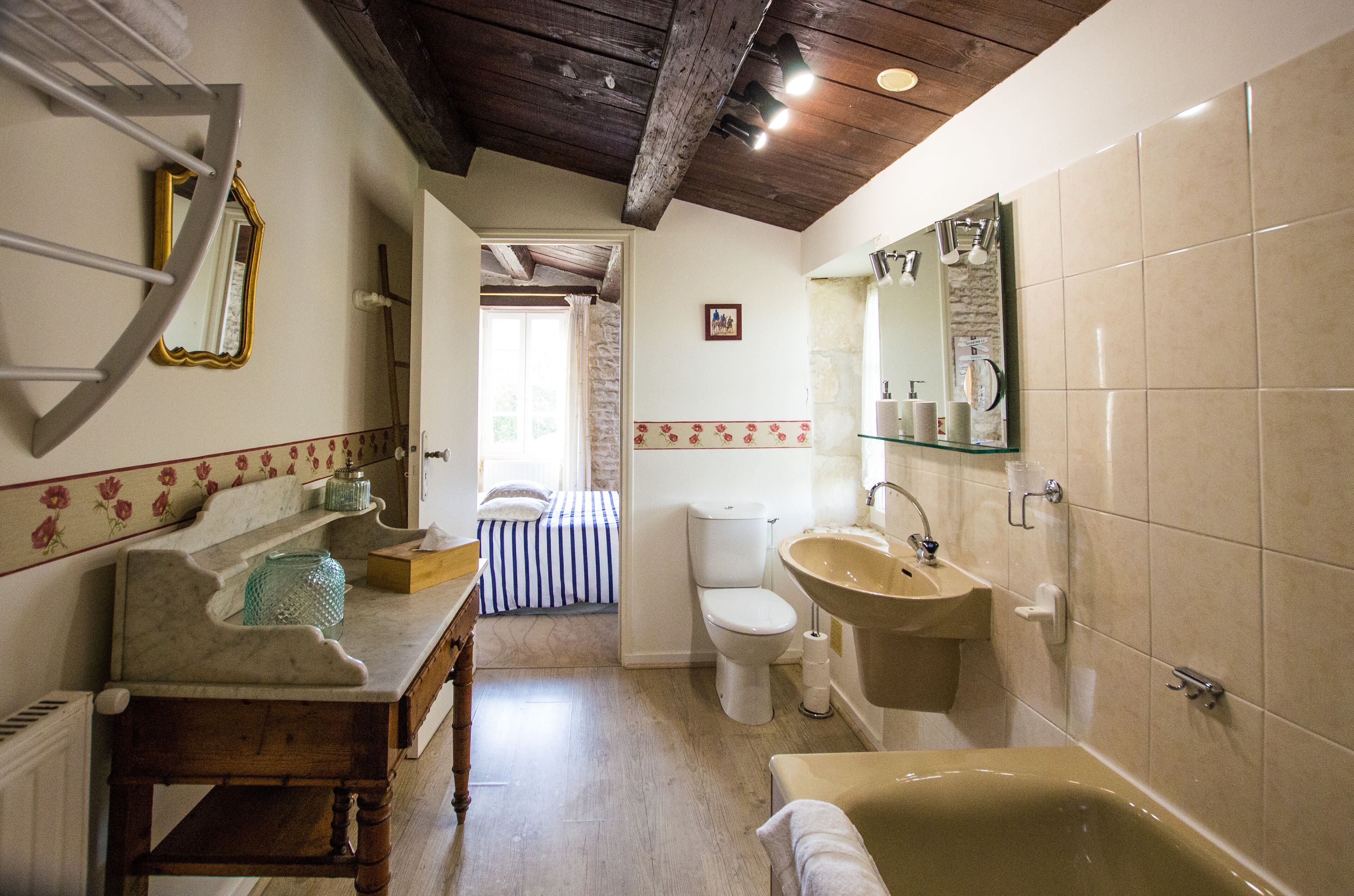 A bathroom with a bathtub, sink, and toilet.
