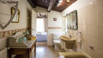 A bathroom with a bathtub, sink, and toilet.