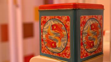 A blue and red container with a fish design on the front.