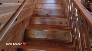 A wooden staircase with a handrail leading to an upper level. - Peaceful Blue Ridge Mountain Retreat Near Marion, NC (Nebo)