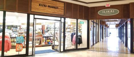 A shopping mall corridor with stores like Ku'ai Market and Ilikai Shops.