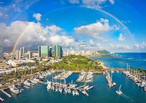 Overlooking a bustling marina with modern high-rise buildings, this location offers stunning city views.