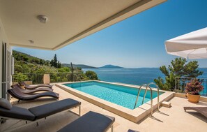 Outdoor pool, a heated pool, sun loungers